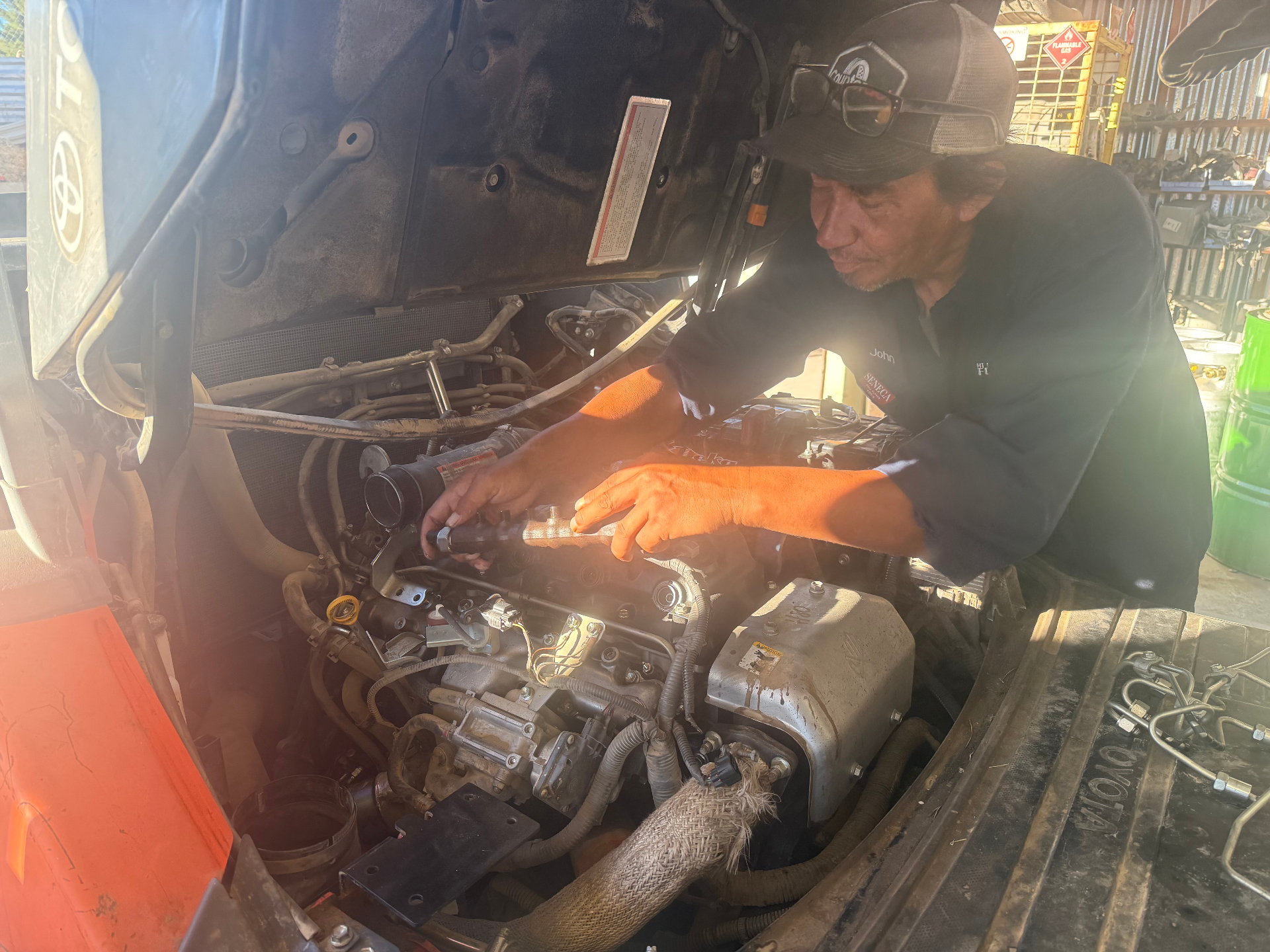 Hi Desert Forklift technician repairing a forklift engine