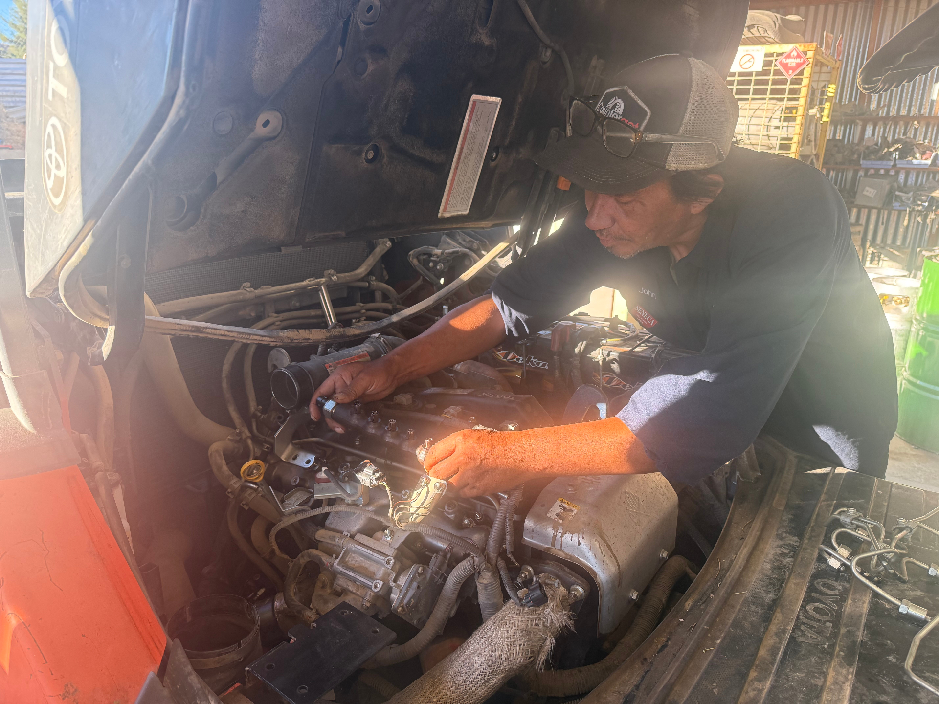 Hi Desert Forklift technician working on a forklift in the Victorville shop